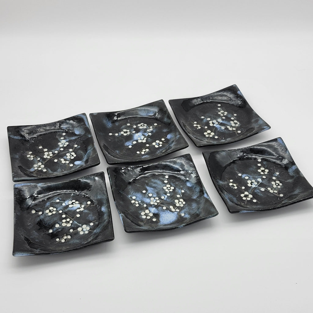 Set of six black square ceramic plates with white blossom design