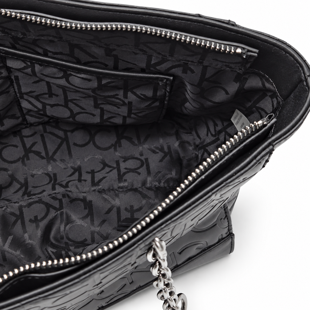 Calvin Klein black tote interior with monogram lining and zipper pocket