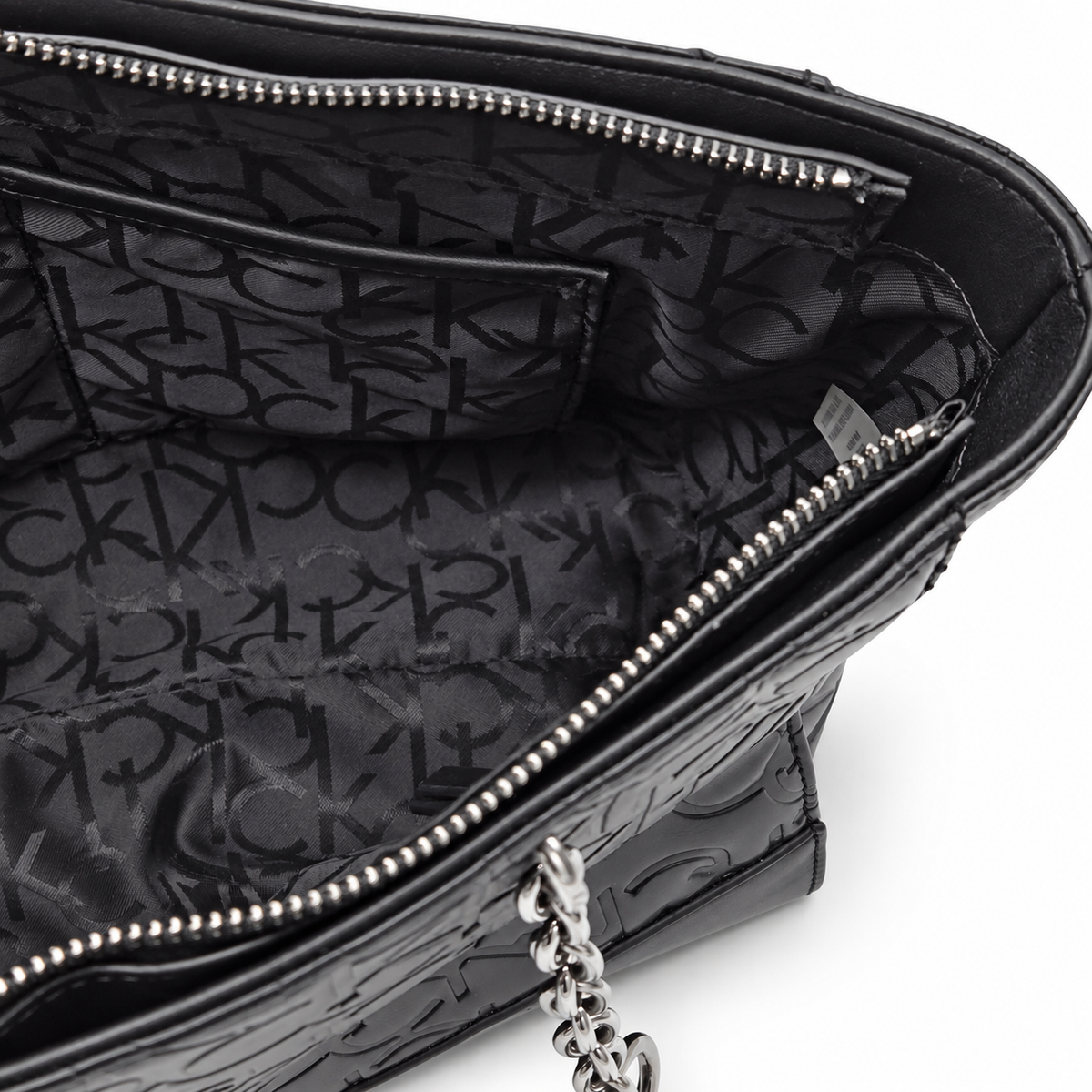 Calvin Klein black tote interior with monogram lining and zipper pocket