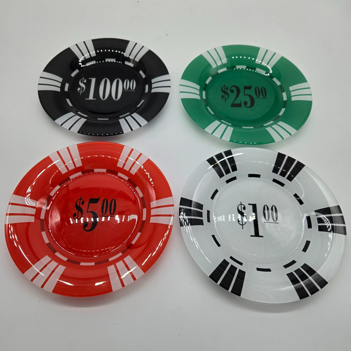 Set of four glass plates designed like casino poker chips in $1, $5, $25 and $100 denominations