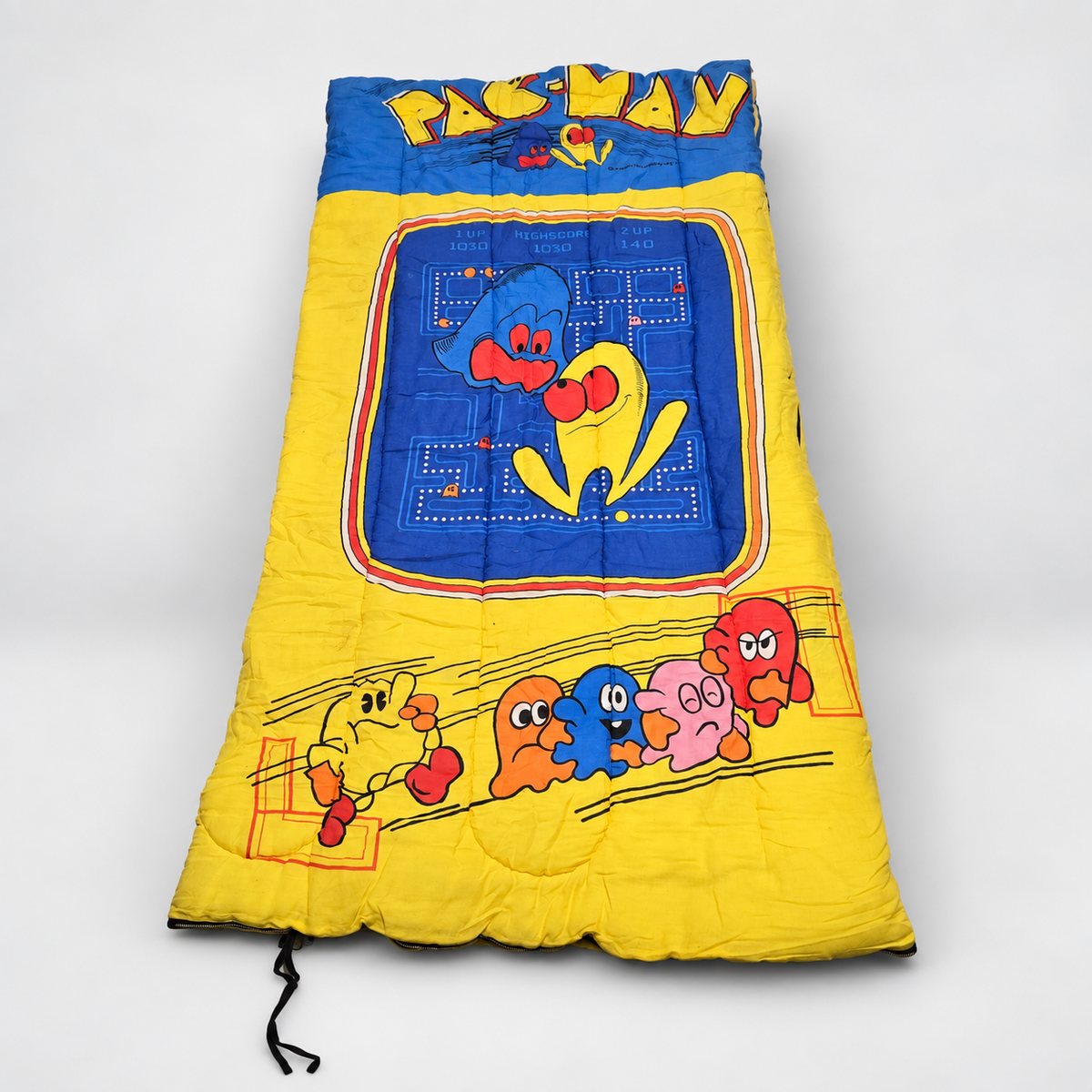 Vintage Pac-Man arcade sleeping bag in blue and yellow with classic Midway character graphics
